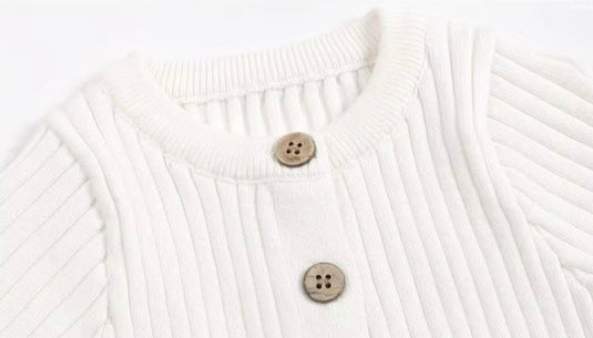 Baby girl's white knitted cotton long-sleeved romper